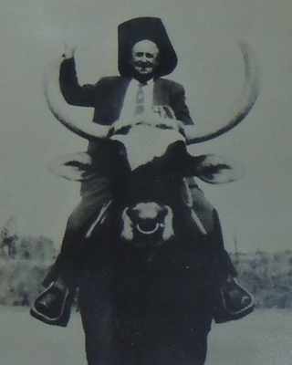 M.A. Fortune riding water buffalo